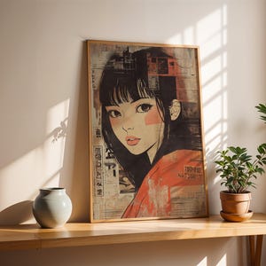 May include: A framed print of a woman with black hair and a red and white patterned shirt. The print has Japanese text on it.