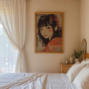 May include: A white bed with white linen and pillows in a bedroom with a window and white curtains. A framed print of a woman with black hair and a red shirt is on the wall above a wooden bedside table with a white candle and a vase with green plants.