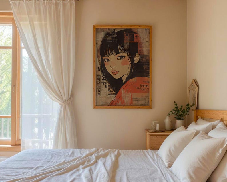 May include: A white bed with white linen and pillows in a bedroom with a window and white curtains. A framed print of a woman with black hair and a red shirt is on the wall above a wooden bedside table with a white candle and a vase with green plants.