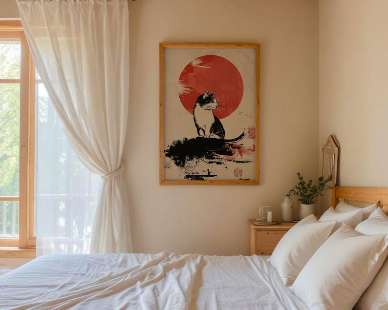May include: A black and white illustration of a cat sitting in front of a red sun on a white background. The illustration is framed in a wooden frame.