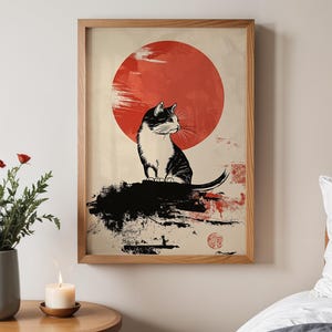 May include: A black and white illustration of a cat sitting on a rock with a large red sun behind it. The image is in a minimalist style with a Japanese aesthetic.