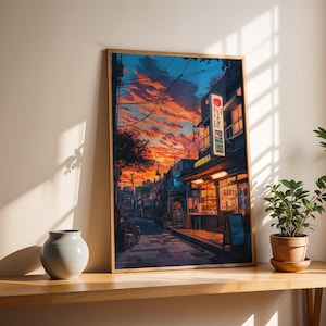 Puede incluir: Una pintura enmarcada de una calle estrecha en Jap&oacute;n al atardecer. La calle est&aacute; bordeada de edificios, algunos con arquitectura japonesa tradicional. El cielo es de un naranja y rosa vibrantes, con nubes y l&iacute;neas el&eacute;ctricas. La calle est&aacute; vac&iacute;a, excepto por una sola figura que se aleja del espectador.