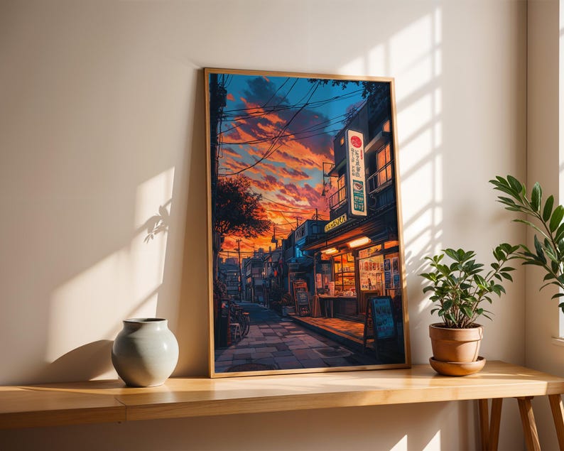 Puede incluir: Una pintura enmarcada de una calle estrecha en Jap&oacute;n al atardecer. La calle est&aacute; bordeada de edificios, algunos con arquitectura japonesa tradicional. El cielo es de un naranja y rosa vibrantes, con nubes y l&iacute;neas el&eacute;ctricas. La calle est&aacute; vac&iacute;a, excepto por una sola figura que se aleja del espectador.