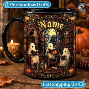 May include: A black ceramic mug featuring a colorful stained-glass style illustration of three ghosts reading books in a library. The design includes pumpkins, a raven, a skull, and the text Name in gold lettering at the top of the arched window.