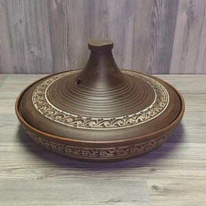 Deep ceramic tagine dish for roasting meat and stews