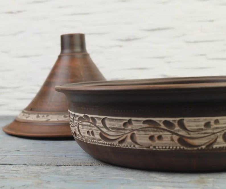 Side view of carved terracotta tagine pot