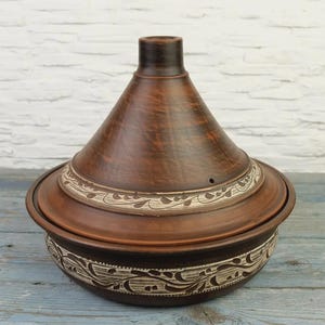 Close-up carved clay pottery tagine design