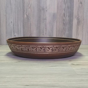 Rustic earthenware tagine dish for traditional recipes