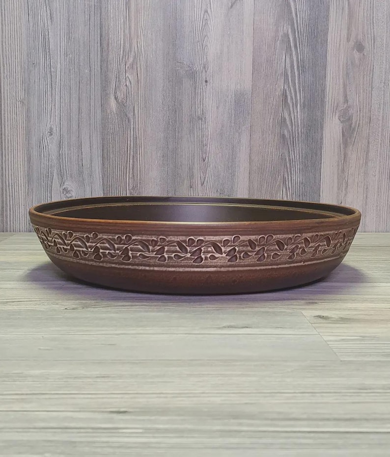 Rustic earthenware tagine dish for traditional recipes