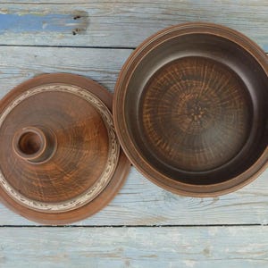 Clay tagine pot for oven cooking, carved pottery