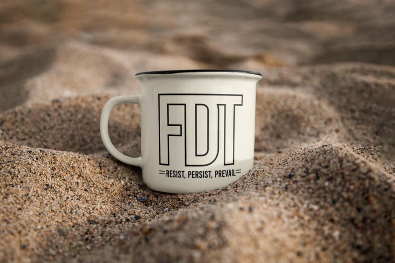 May include: White enamel mug with a black rim and handle. The mug has a black graphic that says "FDT = RESIST, PERSIST, PREVAIL" on the front.