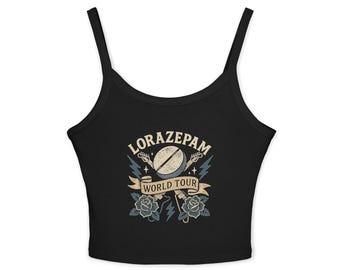 May include: Black tank top with a graphic design featuring the text "LORAZAPAM WORLD TOUR". The design includes a pill, guitars, lightning bolts, and roses in a vintage style.