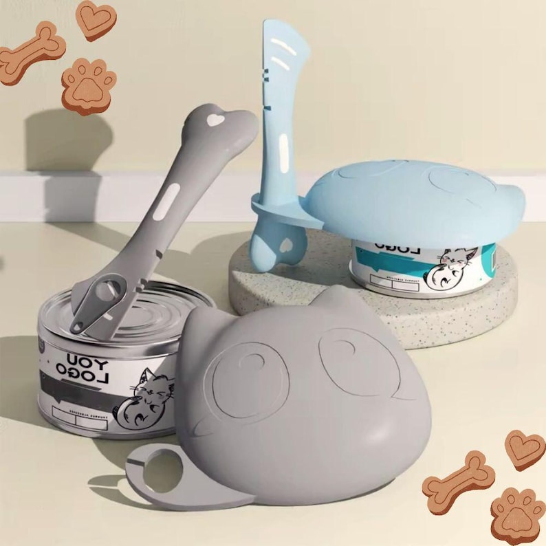 K&ouml;nnte beinhalten: Ein Set aus drei Katzen-Tierfutter-Accessoires. Ein grauer katzenf&ouml;rmiger Deckel mit Griff, ein blauer katzenf&ouml;rmiger Deckel mit Griff und ein grauer Dosen&ouml;ffner mit knochenf&ouml;rmigem Griff.