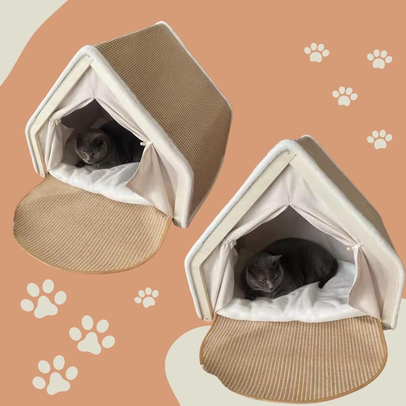 May include: Two cat houses with a beige woven exterior and a cream-colored interior. Each house has a gray cat resting inside on a white cushion. The houses have a roof-like shape and a woven mat at the entrance.