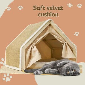 May include: A beige cat house with a light-colored trim and curtains. A gray cat is lying inside the house. The text "Soft velvet cushion" is above the house. The background is a light orange color with paw prints.