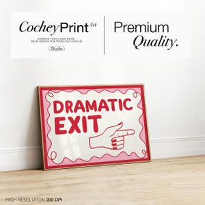 May include: A framed print with the words "DRAMATIC EXIT" in red, with a hand pointing right. The print has a pink border and is set against a white background. The image also includes the text "CocheyPrintArt" and "Premium Quality."