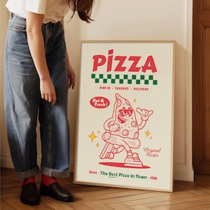 May include: A framed poster with a retro pizza design. The word "PIZZA" is in red, above a green and white checkered pattern. A cartoon pizza slice with sunglasses is giving a thumbs up. Text includes "Dine In, Takeout, Delivery", "Hot & Fresh!", and "Since The Best Pizza In Town 1981".