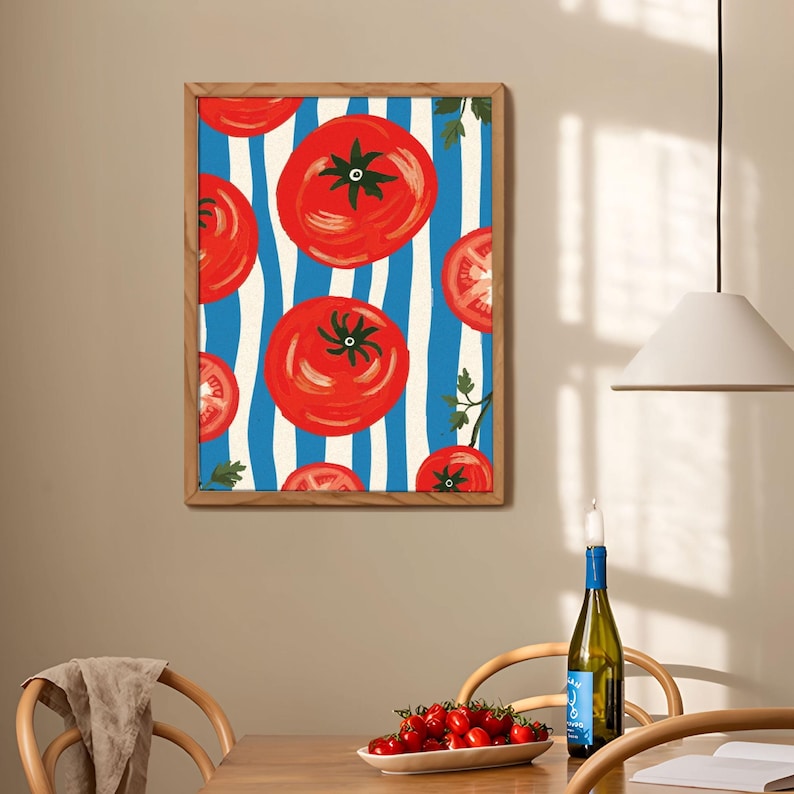 May include: A framed print with a red tomato pattern on a blue and white striped background. The tomatoes are painted in a stylized manner with a red, orange, and yellow color scheme.