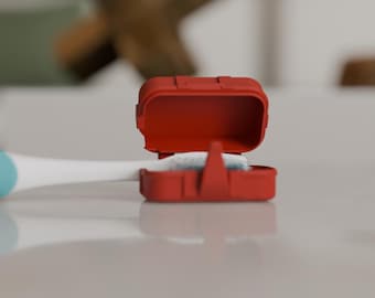 May include: A red toothbrush travel case, open to reveal a white toothbrush head. The case is rectangular with rounded edges and a hinged lid. The toothbrush handle is white with a light blue accent.
