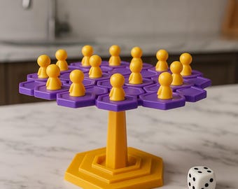 May include: A board game with a purple hexagonal playing surface and yellow game pieces. The game is supported by a yellow stand and base. A white die with black dots sits nearby. The game is set on a marble surface.