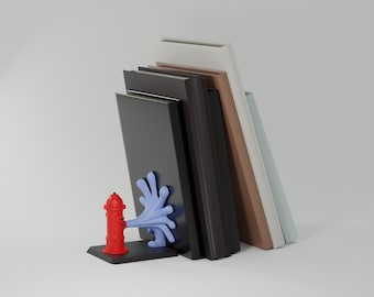 May include: A set of books in various colors, including black, brown, and white, are held in place by a red fire hydrant bookend with blue water spray. The bookend is on a black base, providing a decorative and functional element.