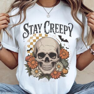 This Skeleton Hand Sublimation PNG brings retro horror charm with a dripping heart design. Perfect for Halloween shirts, gothic decor, spooky party invites, or creepy digital art. High-quality PNG for instant download.

Elevate your Halloween projects with this Stay Creepy Retro PNG. Grunge dripping heart and skeleton hand graphics create the perfect eerie aesthetic for sublimation crafts, apparel, or digital artwork. Instant spooky fun!