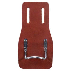 May include: A brown leather tool holder with two vertical slots at the top and a metal handle at the bottom. The holder has a rectangular shape with rounded edges and is designed to be attached to a belt.