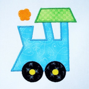May include: A blue train applique with a green roof and orange smoke. The train has black wheels with yellow centers.