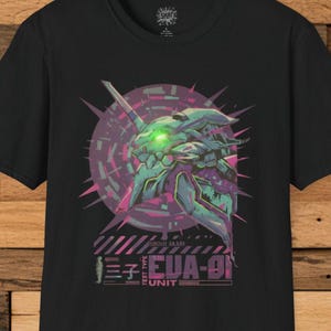 May include: Black t-shirt featuring a graphic of a mecha head with green glowing eyes, set against a purple and pink geometric background. The text "EVA-01" and Japanese characters are printed below the graphic.