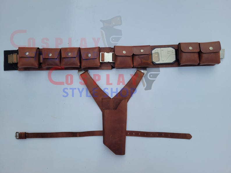 May include: A brown leather utility belt with multiple pouches and a silver buckle. The belt includes a holster and suspenders. The belt is designed for cosplay or costume use.