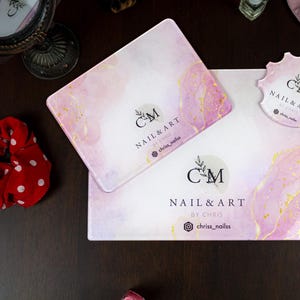 May include: Two pink and gold marble-patterned glass trays with the text "CM NAIL & ART BY CHRIS" and the Instagram handle "chriss_nailss".