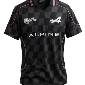 May include: Black and grey chequered Alpine Formula 1 team jersey with pink trim. The jersey features the Alpine logo and the text "ALPINE" in white. The shirt has a V-neck collar and short sleeves.