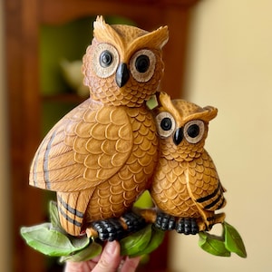 May include: A handmade wooden sign with the text "Welcome" in a handwritten style. The sign is painted white with a distressed finish and features a small, decorative heart. It is designed for indoor or outdoor use.