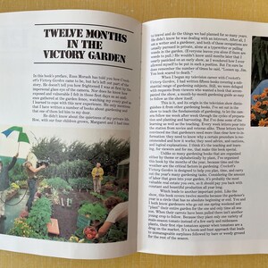 May include: An open book titled Twelve Months in the Victory Garden featuring black text on white pages. The left page shows a photograph of a film crew in a garden, while the right page contains printed text and a portrait of a man with flowers.