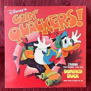 May include: A vintage vinyl record album cover featuring Donald Duck on roller skates, breaking through a red background. The album title "Disney's Goin' Quackers!" is in large orange letters. The cover also includes the text "Starring That Waddlin' Crazy Guy, Donald Duck."