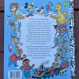 May include: Back cover of a Little Golden Book featuring colorful illustrations of cartoon characters like Mickey Mouse, Donald Duck, and Big Bird. The book's title and description are printed on a light blue background.