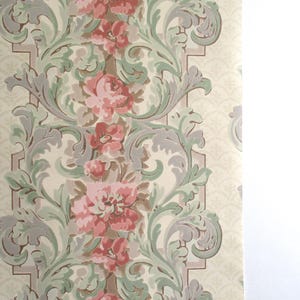 May include: Vintage wallpaper with a repeating floral pattern. The design features pink roses, green leaves, and grey accents on a cream background. The wallpaper has a classic, ornate style.