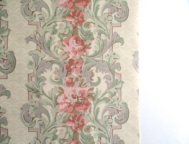 May include: Vintage wallpaper with a repeating floral pattern. The design features pink roses, green leaves, and grey accents on a cream background. The wallpaper has a classic, ornate style.