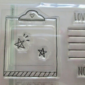 May include: Clear stamp set featuring a clipboard design with a heart and two star shapes. The set includes the text "LOVE this" and other text. Ideal for scrapbooking and crafting projects.