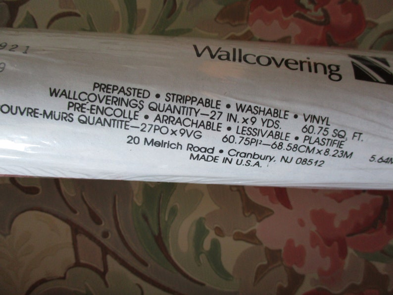 May include: A roll of pre-pasted, strippable, washable vinyl wallcovering. The label indicates a quantity of 68.58cm x 8.23m. The floral design features pink and green hues. Made in the U.S.A.