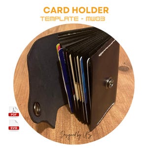 May include: A black leather card holder with a flap that folds over to secure the cards. The holder is open and shows a stack of cards inside. The text "CARD HOLDER TEMPLATE - MW03" is at the top of the image.