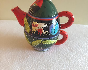 Juego de tetera y taza Bella Casa de Ganz. Decoración de cocina con un divertido diseño de gato, pintada a mano y llena de color.