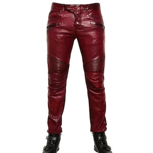 Peut inclure: Pantalon en cuir rouge à coupe slim et aspect vieilli. Le pantalon a une fermeture éclair et des passants de ceinture.