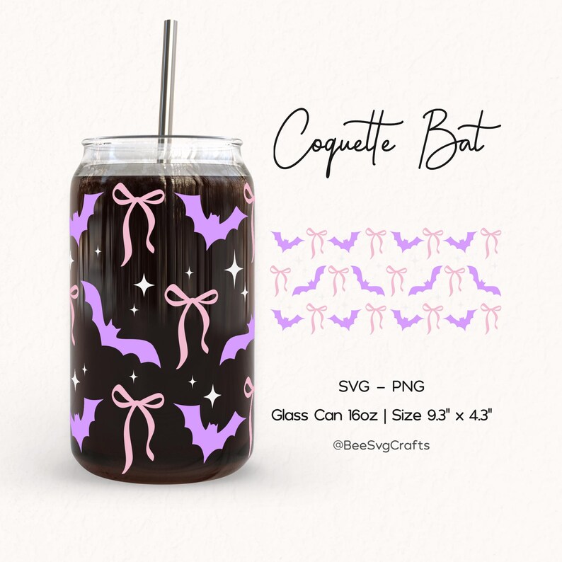 May include: A glass can with a stainless steel straw, decorated with purple bats, pink bows, and white stars. The text "Coquette Bat" is written in a script font. The can is 9.3" x 4.3" and holds 16oz.