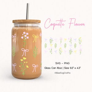 May include: A glass can with a brown lid and a straw. The can is decorated with a pattern of pink, yellow, and green flowers with pink bows. The text "Coquette Flower" is written in pink cursive above the can. The text "SVG - PNG" is written in black below the can. The text "Glass Can 16oz | Size 9.3" x 4.3" is written in black below the text "SVG - PNG". The text "@BeeSvgCrafts" is written in black below the text "Glass Can 16oz | Size 9.3" x 4.3".