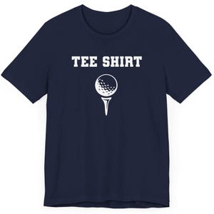 May include: A navy blue t-shirt with the text "TEE SHIRT" in white lettering and a white golf ball on a tee.