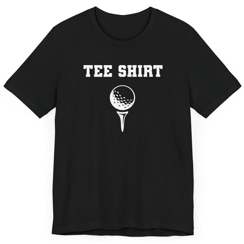 May include: Black t-shirt with white text that says "TEE SHIRT" and a white golf ball graphic.