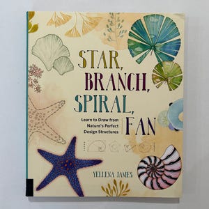 May include: A book titled "STAR, BRANCH, SPIRAL, FAN" with illustrations of a blue starfish, a nautilus shell, and other natural forms. The book cover is beige with green, blue, and yellow accents. The author's name is Yellena James.