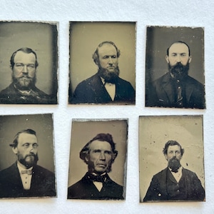 May include: Six antique portrait photographs featuring men with beards and formal attire. The images are rectangular, with a sepia tone and visible wear around the edges, suggesting age and historical significance. The men are in dark suits and bow ties.