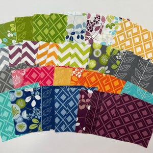 May include: A collection of fabric squares in various colors and patterns, including floral, geometric, and chevron designs. The fabrics feature shades of green, blue, pink, orange, and gray, arranged in a fan shape. Ideal for quilting or crafting projects.